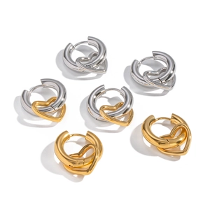 Three pairs of minimalist heart earrings in gold, silver, and bicolor stainless steel