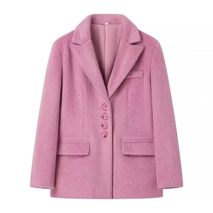Detailed close-up of pink faux fur blazer showing notched lapels and four-button closure