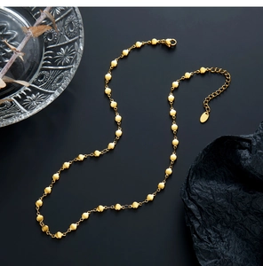 Detailed view of 18K gold plated stainless steel necklace with flat oval disc charms