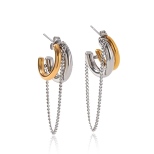 Detail of two-tone gold and silver C-shaped chain tassel earrings on a white background