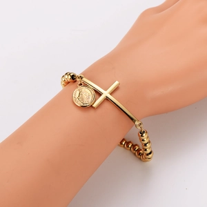Gold beaded stainless steel bracelet with cross and oval religious icon pendants on model