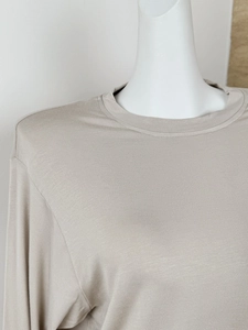 Detail of light khaki long sleeve crew neck T-shirt in soft cotton knitted fabric
