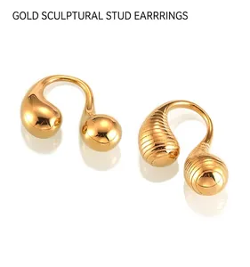 Detail of gold titanium rings showing smooth and spiral textured liquid metal finish