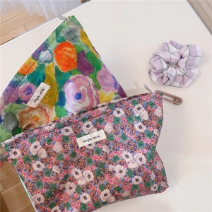 Detail of vintage floral cotton makeup bags with simple wish labels and metal zippers