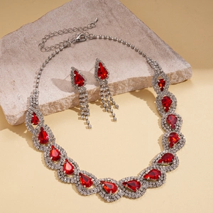Detailed macro shot of vintage drop jewelry set with red gems and silver finish