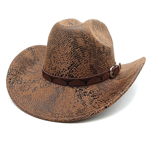 Detail of snake skin texture cowboy hat with brown leather strap and bull head buckle