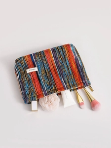 Bohemian striped knit makeup bag with metal zipper and H&R logo for travel storage