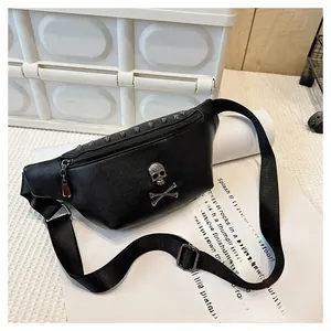 Close-up of black pebble leather waist bag featuring silver skull emblems and punk rivets