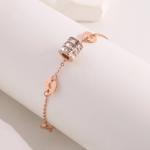 Titanium steel bracelet in rose gold featuring a cylinder diamond pendant and Roman numerals