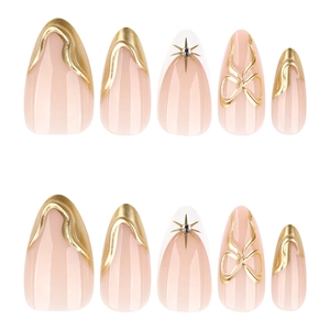 French 3D gold almond press-on nails with nude base, metallic relief, and 3D bow details