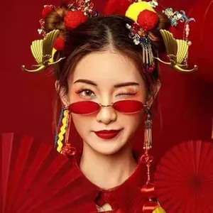 Close-up of vintage red oval sunglasses with traditional Chinese hair accessories and tassels