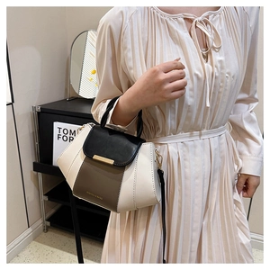 Detail of color-block handheld square bag with professional texture and shoulder strap