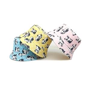 Detail view of cotton bucket hats with panda prints in blue, yellow and pink colors