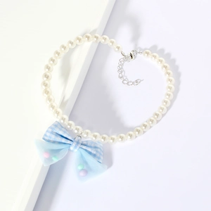 Detail of pet pearl necklace with light blue plaid bow and adjustable silver clasp