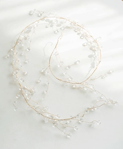 Macro detail of acrylic snowflake beads on light gold flexible wire for Christmas decor