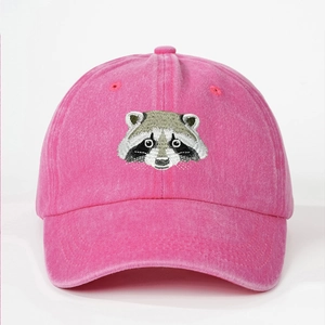 Close-up of raccoon animal embroidery on a pink washed cotton baseball cap texture