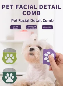 Detail showing the pet facial comb clearing fur around the eyes of a white dog