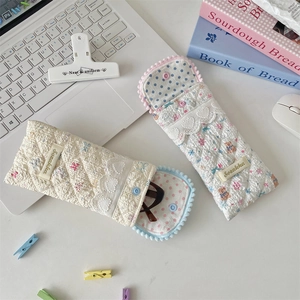 Detailed shot of quilted cotton glasses pouches with heart lace and bear patterns
