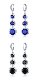 Detail view of drop earrings featuring blue and black center stones with zircon halos