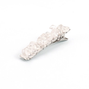 Macro detail of natural crystal stone chips hand-wrapped on a silver metal hair clip