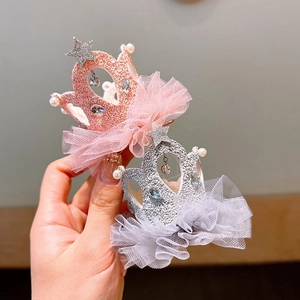 Detail of pink and silver crown hair clips with glitter, lace mesh, and faux pearls