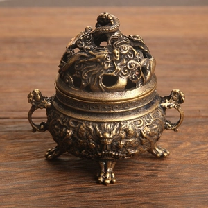 Detailed view of an antique dragon bronze incense burner with hollow lid and lion handles