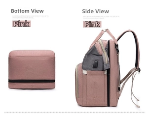 Detailed side view of pink diaper bag showing USB charging port and padded straps