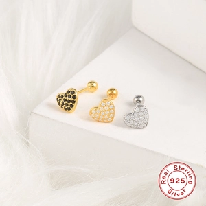 Macro detail of heart-shaped 925 sterling silver stud earrings with glittering crystals