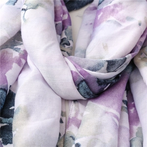 Macro view of floral watercolor pattern and textured fabric on bohemian scarf