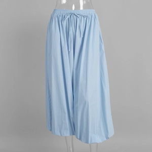 Close-up of light blue cotton lantern pants featuring elastic waist and drawstring detail