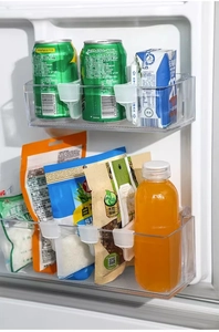 Detail view of adjustable refrigerator divider clips organizing bottles and containers
