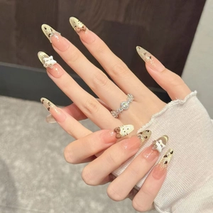 Handmade almond cat-eye press-on nails with leopard print and 3D bow accents