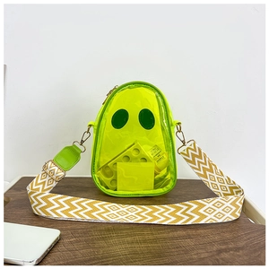 Close-up of clear neon green PVC bag with cartoon smiley face and wide woven strap