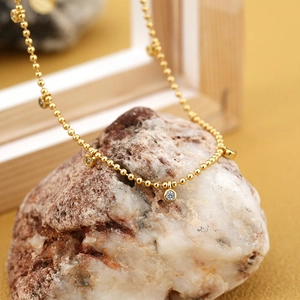 Minimalist gold-plated bead necklace with sparkling bezel-set zircon charms on stones