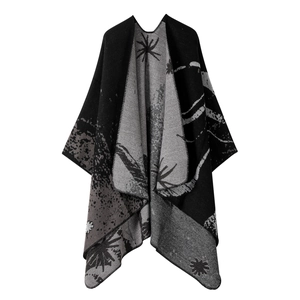 Double-sided black and gray knit shawl with abstract star patterns and stitched edges