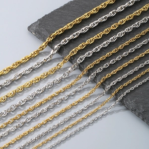 Detailed comparison of various thicknesses of gold and silver rope chains on a stone