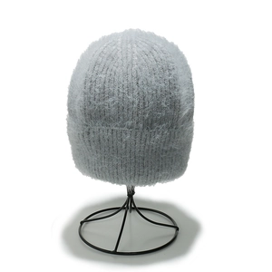 Plush light grey winter knitted hat made of warm faux mink fur for men and women