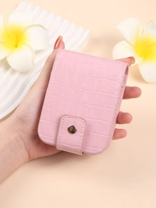 Pink faux leather lipstick pouch with crocodile pattern, mirror, and gold snap button