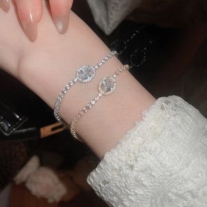 Close-up of elegant gold and silver oval zircon bracelets with sparkling accents