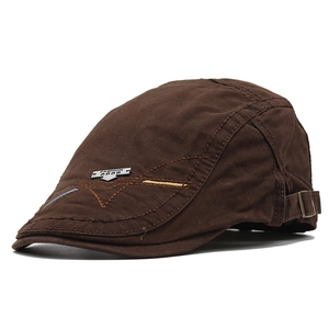 Detail view of cotton flat cap with metal logo, embroidery, and adjustable buckle