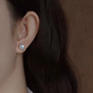 Detailed close-up of a model wearing the baroque pearl earring with S925 silver needle