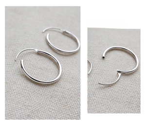 Detail of S925 sterling silver hoop earrings with secure snap closure and hallmark