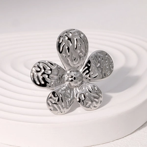 Minimalist silver flower ring with hammered petal texture and unique beaded center