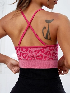 Pink leopard print sports bra with criss-cross back straps and high waist black yoga leggings