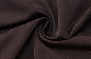 Detail view of deep brown ribbed knit fabric with high elasticity and soft texture
