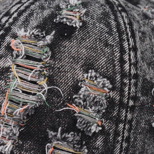 Distressed black denim baseball cap with colorful stitching and ripped details