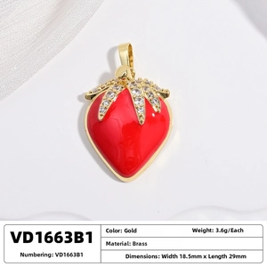 Macro shot of red strawberry pendant with gold leaves and inlaid cubic zirconia