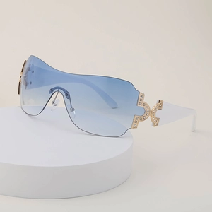 Y2K style oversized rimless sunglasses with blue gradient lenses and rhinestone accents