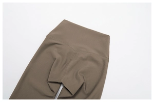 Detail shot of brown ribbed knit high waist yoga pants showing texture and seamless design