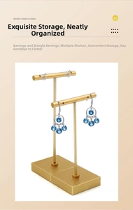 Detail of two golden T-bar metal jewelry stands for elegant earring display